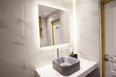 a bathroom with a sink and a mirror at Syntagma Hotel Style Luxury in Athens