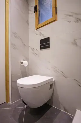 a bathroom with a white toilet and a mirror at Syntagma Hotel Style Luxury in Athens