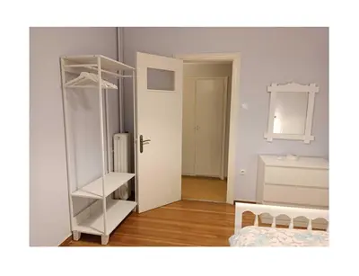 a room with a white shelf and a mirror at Roza's apartment in Athens