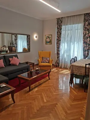 a living room with a couch and a table at Roza's apartment in Athens