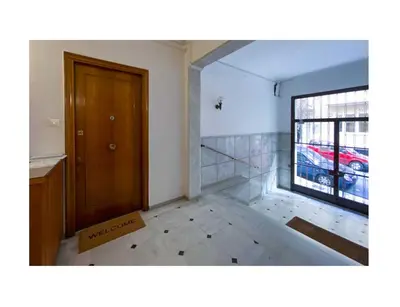 an empty room with a door and a window at Roza's apartment in Athens