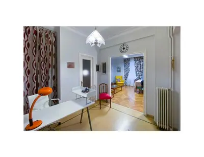 a living room with a table and chairs at Roza's apartment in Athens