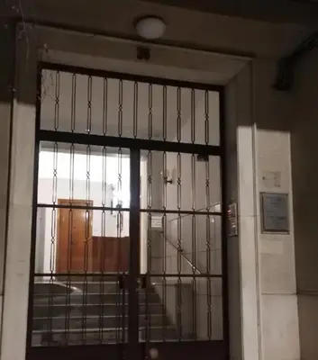 a door with a metal gate in a room at Roza's apartment in Athens