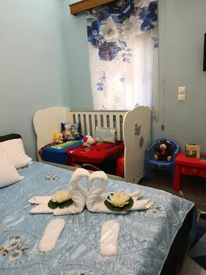 a room with a bed with a table with food on it at Maria Cozy Getaway in Glyfada in Athens