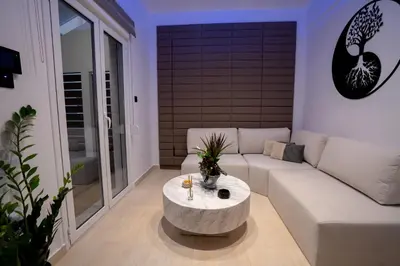 a living room with a couch and a coffee table at V Suites - Apts & Spa in Athens