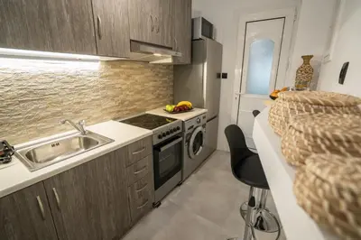 a small kitchen with a sink and a stove at V Suites - Apts & Spa in Athens
