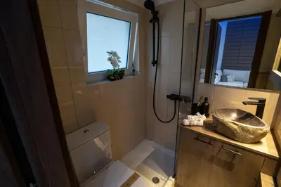 a bathroom with a sink and a shower at V Suites - Apts & Spa in Athens