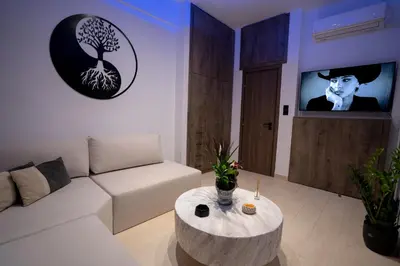 a living room with a white couch and a table at V Suites - Apts & Spa in Athens