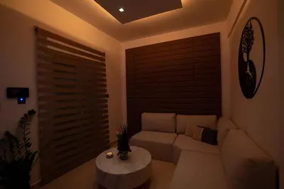 a living room with a couch and a table at V Suites - Apts & Spa in Athens