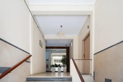 a hallway of a house with stairs and plants at LIV - Elegant City Stay in Pagrati in Athens