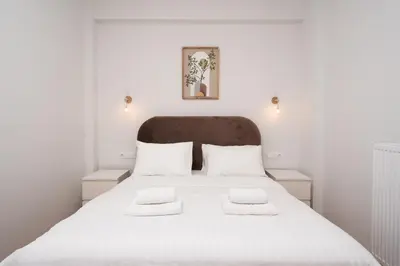 a bedroom with a white bed with two white pillows at LIV - Captivating Apartment in Pagrati in Athens