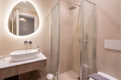 a bathroom with a sink and a shower at LIV - Captivating Apartment in Pagrati in Athens