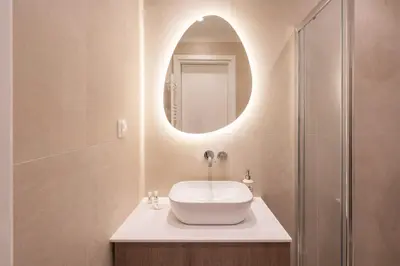 a bathroom with a sink and a mirror at LIV - Captivating Apartment in Pagrati in Athens