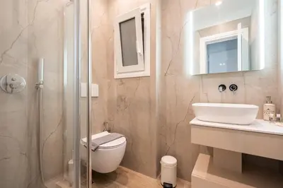 a bathroom with a toilet and a sink and a shower at LIV - Captivating Apartment in Pagrati in Athens