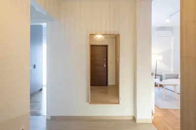 a hallway with a mirror on the wall at LIV - Captivating Apartment in Pagrati in Athens