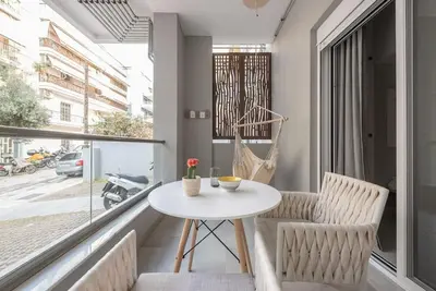 a balcony with a table and chairs and a window at Affordable Luxury with parking 300Mbps wifi in Athens