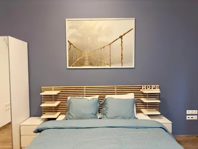 a bedroom with a bridge painting above a bed at Sani Entire Flat near Syntagma Square in Athens