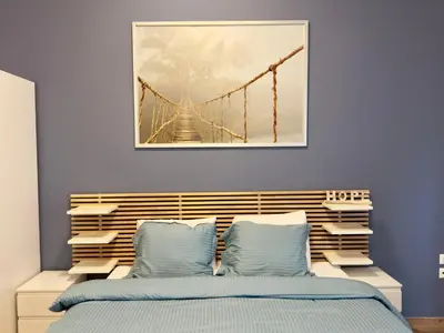 a bedroom with a bridge painting above a bed at Sani Entire Flat near Syntagma Square in Athens