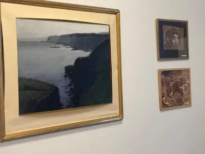 a group of paintings hanging on a wall at Sani Entire Flat near Syntagma Square in Athens