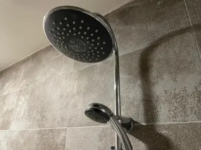 a shower with a shower head in a bathroom at Sani Entire Flat near Syntagma Square in Athens