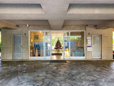 a building with doors and a christmas tree in it at Glyfada central seaside apartment in Athens