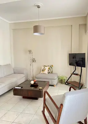 a living room with a couch and a table at Carones apartment in Athens