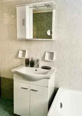 a bathroom with a white sink and a mirror at Carones apartment in Athens