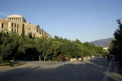 a street in front of a building with trees at Artemis ktparadise in Athens