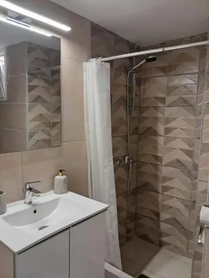 a bathroom with a sink and a shower with a shower curtain at Artemis ktparadise in Athens