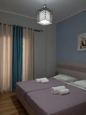 a bedroom with two beds with towels on them at Artemis ktparadise in Athens