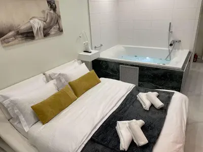 a bedroom with a bed and a bath tub at Romantic Jacuzzi&Spa Residence Near Acropolis- Fix Metro 180m in Athens