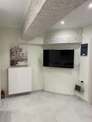 a living room with a flat screen tv on a wall at Romantic Jacuzzi&Spa Residence Near Acropolis- Fix Metro 180m in Athens