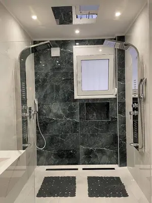 a bathroom with a shower with a tv on the wall at Romantic Jacuzzi&Spa Residence Near Acropolis- Fix Metro 180m in Athens
