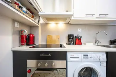 a kitchen with a washing machine and a sink at Acropolis 5 Hills 1st FLR Aprt by Lodgespot in Athens