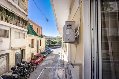 a view from a window of a street with parked motorcycles at Acropolis 5 Hills 1st FLR Aprt by Lodgespot in Athens