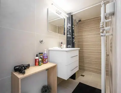 a bathroom with a white sink and a shower at Acropolis 5 Hills 1st FLR Aprt by Lodgespot in Athens