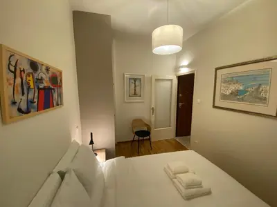 a bedroom with a white bed in a room at Irene's studio in Athens