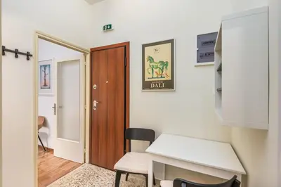a room with a door and a desk with a laptop at Irene's studio in Athens