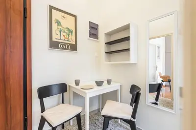 a small table and two chairs in a room at Irene's studio in Athens