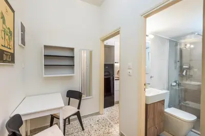 a bathroom with a desk and a sink and a toilet at Irene's studio in Athens