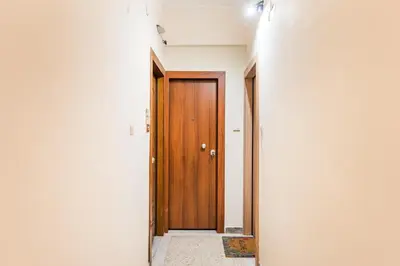 a corridor with a wooden door in a room at Irene's studio in Athens