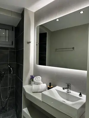 a bathroom with a sink and a mirror at MMs house at Mikrolimano in Piraeus