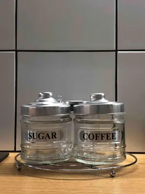 two glass containers sitting on top of a table at AIOLOS Pagrati Athens Hilton near METRO station in Athens