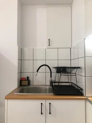a kitchen with a sink and a faucet at AIOLOS Pagrati Athens Hilton near METRO station in Athens