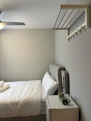 a bedroom with a bed and a nightstand with a table at Family Suite by Zeussuites in Athens