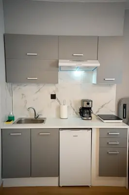 a kitchen with a sink and a counter top at Family Suite by Zeussuites in Athens