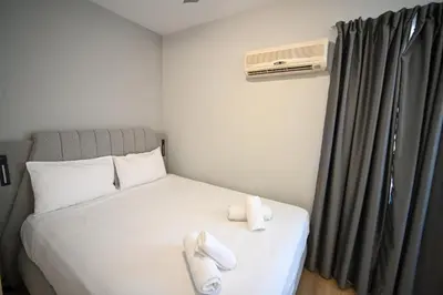 a bedroom with a bed with two towels on it at Family Suite by Zeussuites in Athens