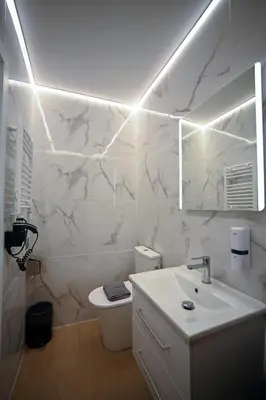 a white bathroom with a sink and a toilet at Family Suite by Zeussuites in Athens