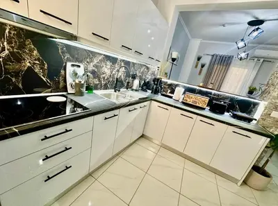 a kitchen with white cabinets and a sink at Casa Di Leandro in Athens