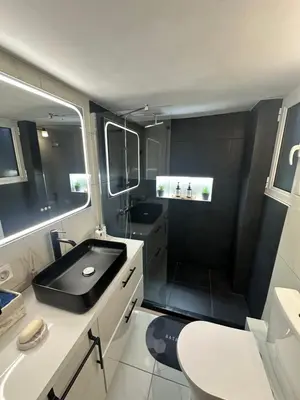 a bathroom with a black sink and a toilet at Casa Di Leandro in Athens